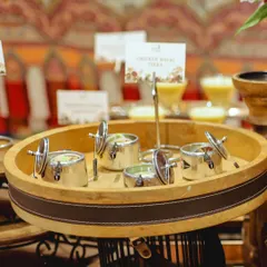 A tray of Chicken Malai Tikka served in my signature mini pressure cookers. This presentation style is always a conversation starter at events.
