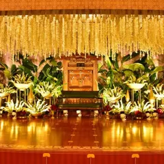Another look at this regal engagement setting, highlighting the magnificent canopy of flowers and the warm lighting that makes the stage glow. We focus on creating a central space that is perfect for blessings and photographs.