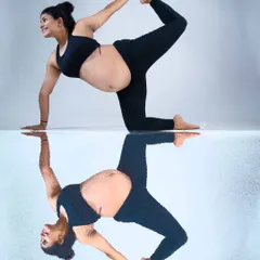 A playful and creative reflection shot. This image captures a mom-to-be doing a yoga pose, with her reflection creating a perfectly symmetrical and visually interesting portrait.