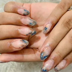 A "watercolor" or "marble ink" effect using shades of blue and bronze on a sheer base for an abstract, artistic look.