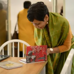 A guest browses a book at our Wingword Poetry Prize 2023 Award Ceremony. Our events are a chance for the literary community to gather, socialize, and appreciate the work of emerging poets.