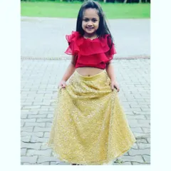 Little Bianca looks adorable in this custom lehenga set. It features a gold embellished skirt paired with a fun and modern red organza ruffle blouse.