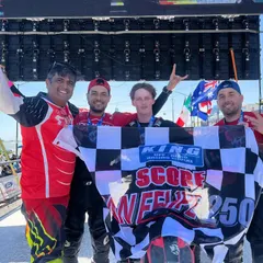 The reward for all the hard work. Our team celebrating a podium finish at the San Felipe 250, holding the checkered flag high. This is what happens when passion and preparation meet.
