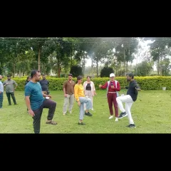 Leading a balancing game during a corporate team building event. These kinds of physical and mental challenges are a great way to get team members to work together and support each other.