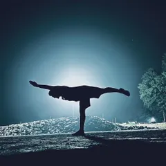 Practice comes first. A silhouette of Virabhadrasana III (Warrior III) against the night sky.