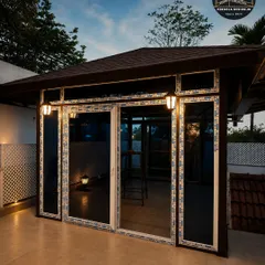 As dusk settles, the same glass room transforms into a cozy, illuminated haven. The integrated exterior lighting enhances the architectural features while creating a warm and inviting atmosphere for evening relaxation.