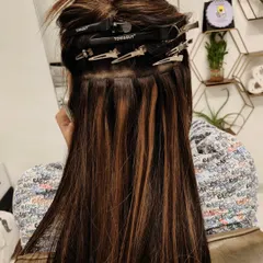 This image displays a completed row of tape-in extensions. Notice how flat the wefts lie against the head, a result of the proper placement techniques I teach in my course.