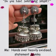 In my world, a bold, heavily oxidised statement jhumka is the perfect touch of minimalism. This pair, with its intricate peacock design and layered domes, is for those who love their jewellery to tell a story.