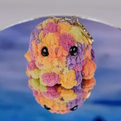 A close-up of one of my multi-colored octopus plushie keychains. The soft texture and vibrant, blended yarn make each one unique and irresistibly cute.