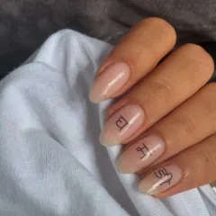 These are called "soap nails" for their super clean, glossy, and natural look. The tiny script adds a personal, delicate touch.