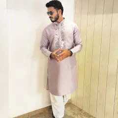 Lavender is a fresh and trendy color for wedding functions. This kurta features intricate mirror work around the neckline, adding a touch of sparkle to a soft and elegant look.