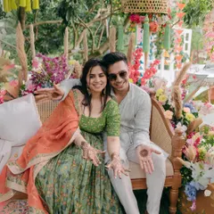 A perfect Mehendi moment. We created this colorful, boho-chic seating with rattan furniture and an explosion of vibrant florals, making it a beautiful backdrop for the happy couple.