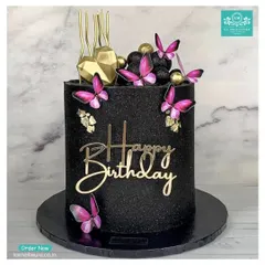 Let's create something bold and glamorous for your birthday. This striking custom cake is covered in black glitter and decorated with vibrant magenta butterflies, gold accents, and a stylish 'Happy Birthday' acrylic topper.