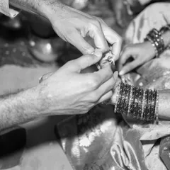 Some moments are so profound they feel timeless. This black and white photograph captures the intimate detail of a ring exchange during a wedding ceremony. By focusing on the hands and the ritual, we preserve the quiet, emotional core of the commitment being made.