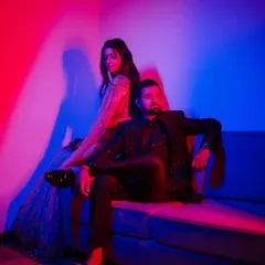 A bold and modern portrait using red and blue colored gels. This lighting technique creates a vibrant, high-fashion look that is perfect for couples wanting something edgy and artistic.