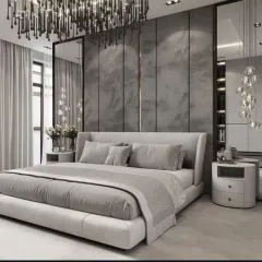 A contemporary bedroom design in cool grey tones. The feature wall behind the bed uses textured panels and full-length mirrors to create a sense of space, complemented by modern cascading pendant lights.