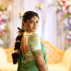 I believe in elegance that feels effortless. This look for a special event features soft, glowing makeup that enhances natural beauty, paired with a beautifully braided hairstyle and a pastel green saree. It's a perfect example of sophisticated party makeup.