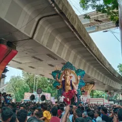 The energy of an idol procession is unmatched. Here you can see the Kamathipura cha Mahaganpati, one of my large-scale creations, making its way through the streets of Mumbai, a testament to the city's grand Ganeshotsav spirit.