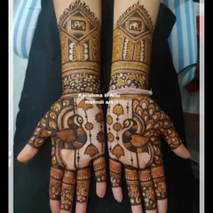 Here, I've combined figurative art with architectural details. The design features peacocks, hanging jhumkas, and jharokhas containing elephants, showcasing how to build a narrative within a bridal mehendi layout.