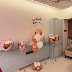 We love creating the perfect birthday aesthetic. This assorted balloon bouquet features rose gold hearts, a personalized "Happy Birthday Queen" bubble balloon, and a soft pastel color palette for a totally chic celebration.