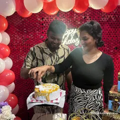 A couple cutting their cake in front of a shimmering red sequin backdrop during their private theatre surprise. It's a celebration fit for the big screen.