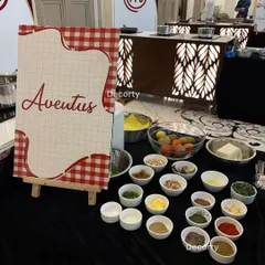 Each team gets a fully prepped station with a variety of fresh ingredients and spices. This image shows the 'Aventus' team's table, laid out with everything they need for the culinary challenge.