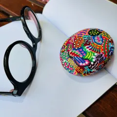 Another look at the 'joy pebble'. The intricate, colorful patterns are all done freehand, making each paperweight a one-of-a-kind creation.