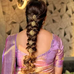 The traditional South Indian bridal hairstyle is an art form. This is a beautifully executed braid, adorned with classic gold "jadanagam" hair ornaments.