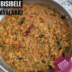 A hot pan of Bisibele Avalakki, a wholesome one-pot meal. It's a quicker version of the classic Bisibelebath, made with flattened rice, lentils, vegetables, and my special spice blend.