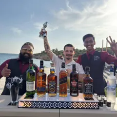 Our team celebrating a successful beachside event. We bring top-shelf spirits and top-tier service, no matter the location.