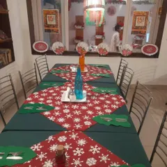 Our tables are set for a magical Christmas experience. The festive runners and decor create a warm, inviting atmosphere for your holiday gatherings.