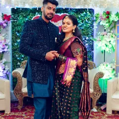 A classic posed portrait of a newly engaged couple in their traditional Maharashtrian attire, perfect for sharing the happy news.