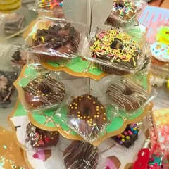 Here are my mini donuts displayed on a cute stand at an exhibition. They are individually wrapped to keep them fresh and make them easy to serve at parties.