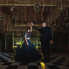 A couple shares their first dance as husband and wife under a ceiling of cascading fairy lights and disco balls, creating a truly magical atmosphere.