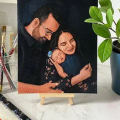 This intimate portrait captures the quiet love of a new family. The dark, moody background helps create a serene atmosphere, focusing all the attention on the parents and their newborn.