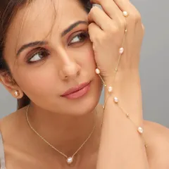 The gorgeous Rakul Preet for Mia by Tanishq. This is a classic beauty shot for a jewelry campaign, using soft, clean lighting to highlight the delicate pearl jewelry and her natural beauty.