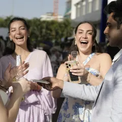 Laughter and disbelief. Performing for a group of friends at the Indore wedding, creating a fun, lighthearted atmosphere during the celebrations.