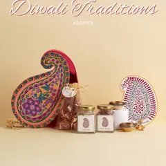 The "Diwali Traditions" hamper, presented in a unique paisley-shaped box. It’s a modern take on classic gifting, containing saffron, almonds, and traditional diyas.