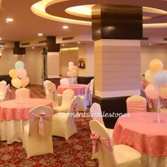 The guest seating area for the candy-themed party, with tables and chairs decorated in coordinating pastel colors.