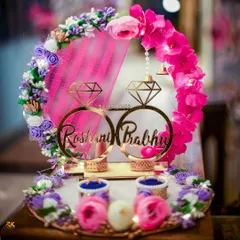 A beautifully decorated engagement ring platter, personalized with the couple's names. This detail shot captures the thoughtful and customized elements that make the ceremony special.