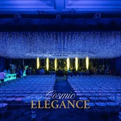The entire venue was bathed in cosmic elegance, with a ceiling of a thousand twinkling lights creating a galaxy overhead. This wide view shows the immersive seating arrangement, designed to make every guest feel like they are part of a celestial event.