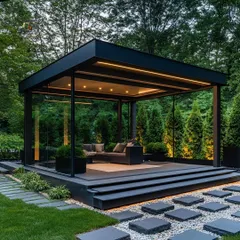We constructed this freestanding glass garden room as a tranquil retreat. The minimalist black frame, glass walls, and integrated lighting create an elegant, self-contained space that feels both enclosed and completely connected to the surrounding nature.