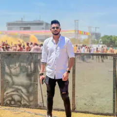 Taking a moment before the color explosion. A shot of me at an outdoor Holi event, ready to take the stage and start the party.