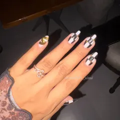 Trust me, these nails are an addiction. This classy and bold set features a black and white checkerboard pattern with gold chrome accents and a Chanel logo nail.