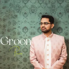 A classic groom portrait of Pawan in his elegant pink sherwani. The textured background and soft lighting create a refined and stylish look.