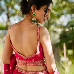 It's all in the details. This shot highlights the beautiful back and intricate embroidery of a festive pink lehenga, perfect for a daytime wedding function. I focus on capturing the craftsmanship that makes each piece special.