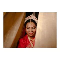 A serene portrait of the Bengali bride, her eyes closed, taking in the moment before the ceremony.