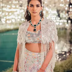 A closer look at the details of Manisha's sangeet outfit. The intricate floral work and the stunning emerald necklace create a look that is both glamorous and artistic.