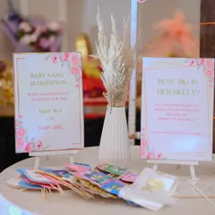 A station for baby shower games and activities. We provide beautifully designed cards for "Baby Name Suggestions" and "How Big is Her Belly?", along with fun photo booth props to keep guests entertained.