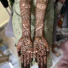 A closer look at a personalized bridal design. I incorporated the couple's initials "KK" and a symbol of two rings, surrounded by classic floral and geometric patterns that cover the hands and forearms.